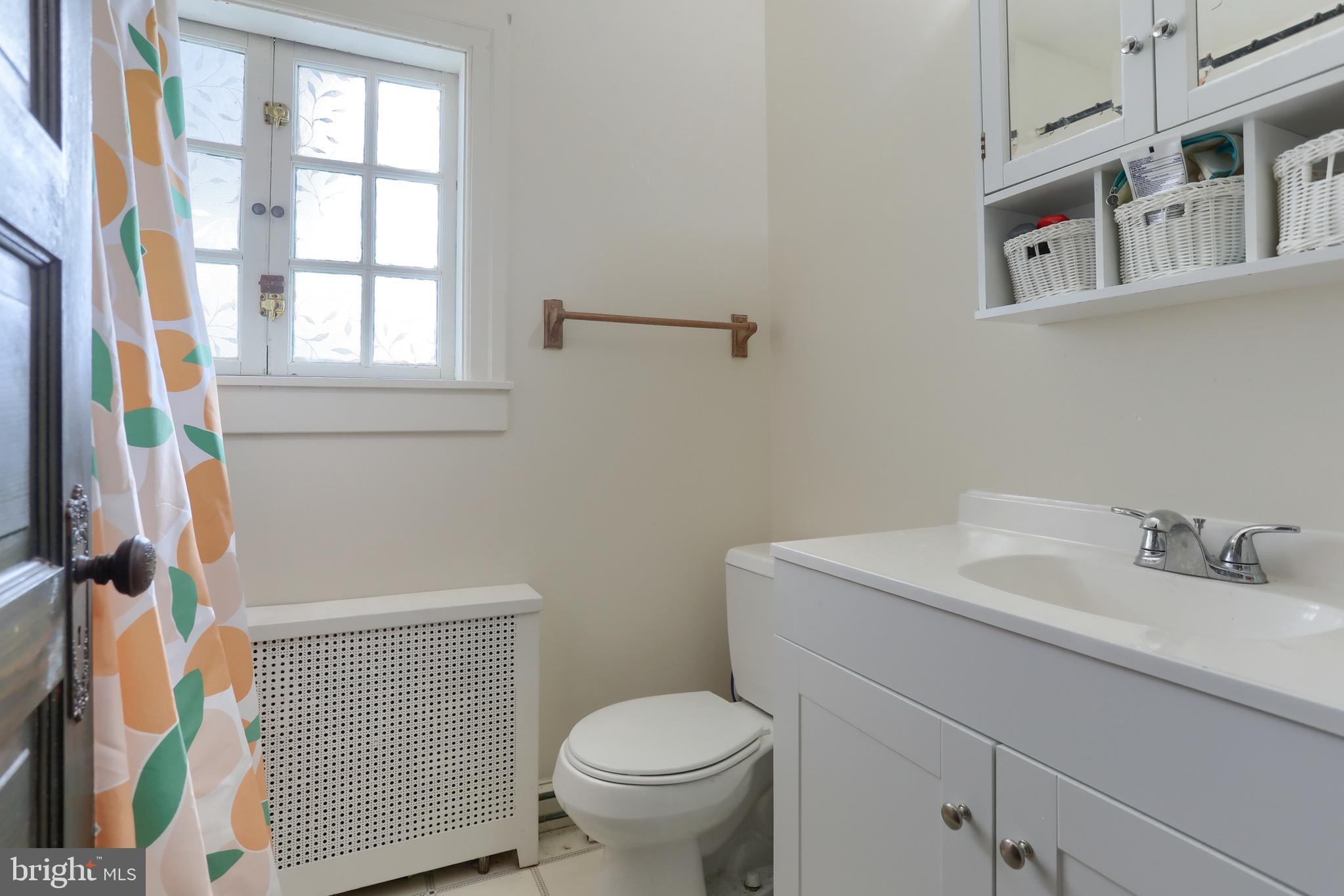229 Cocoa Avenue Hershey, PA 17033 - Photo 17 of 28 a bathroom with a sink toilet and a window