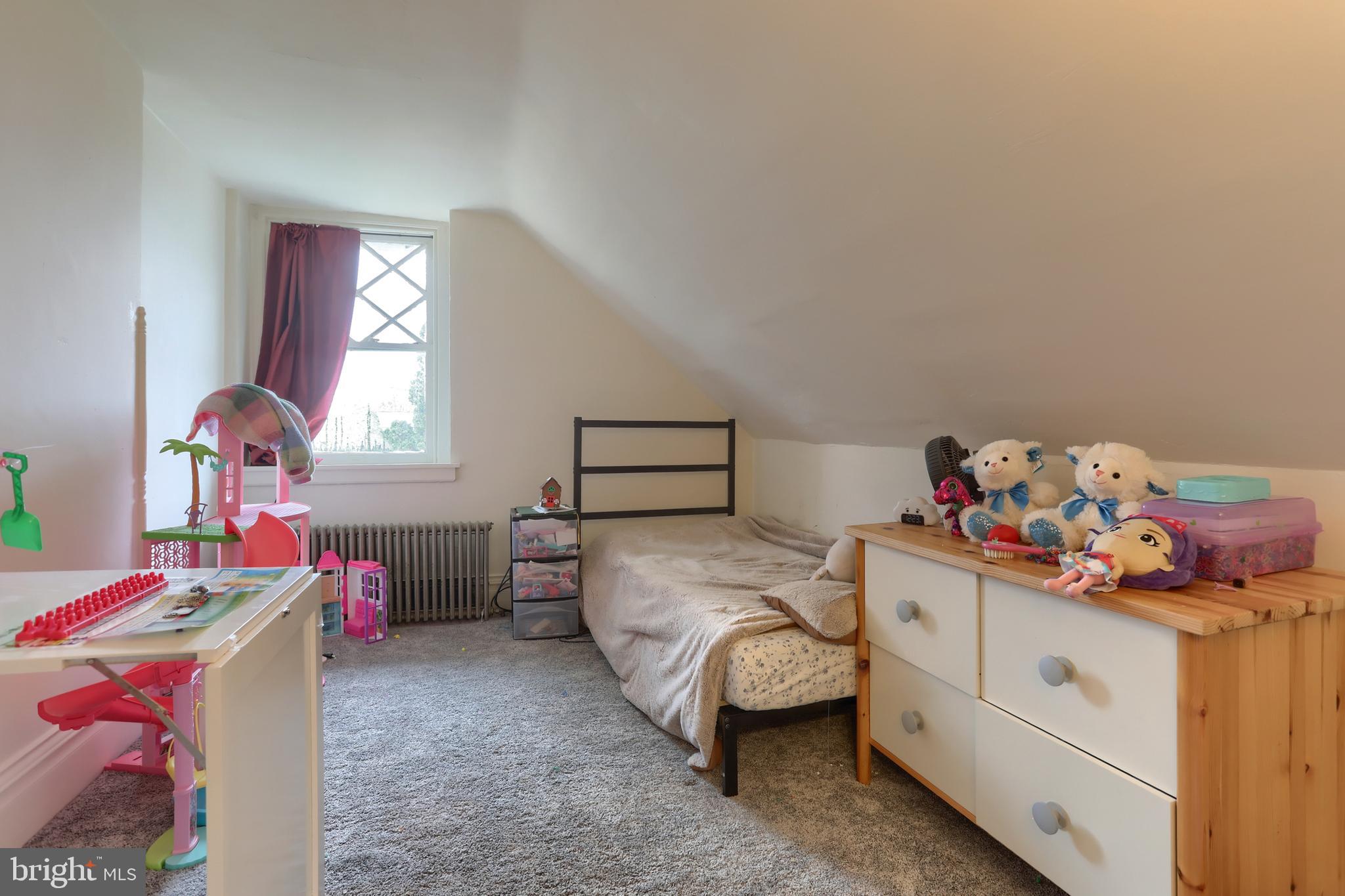 229 Cocoa Avenue Hershey, PA 17033 - Photo 20 of 28 a bedroom with a bed and a chandelier