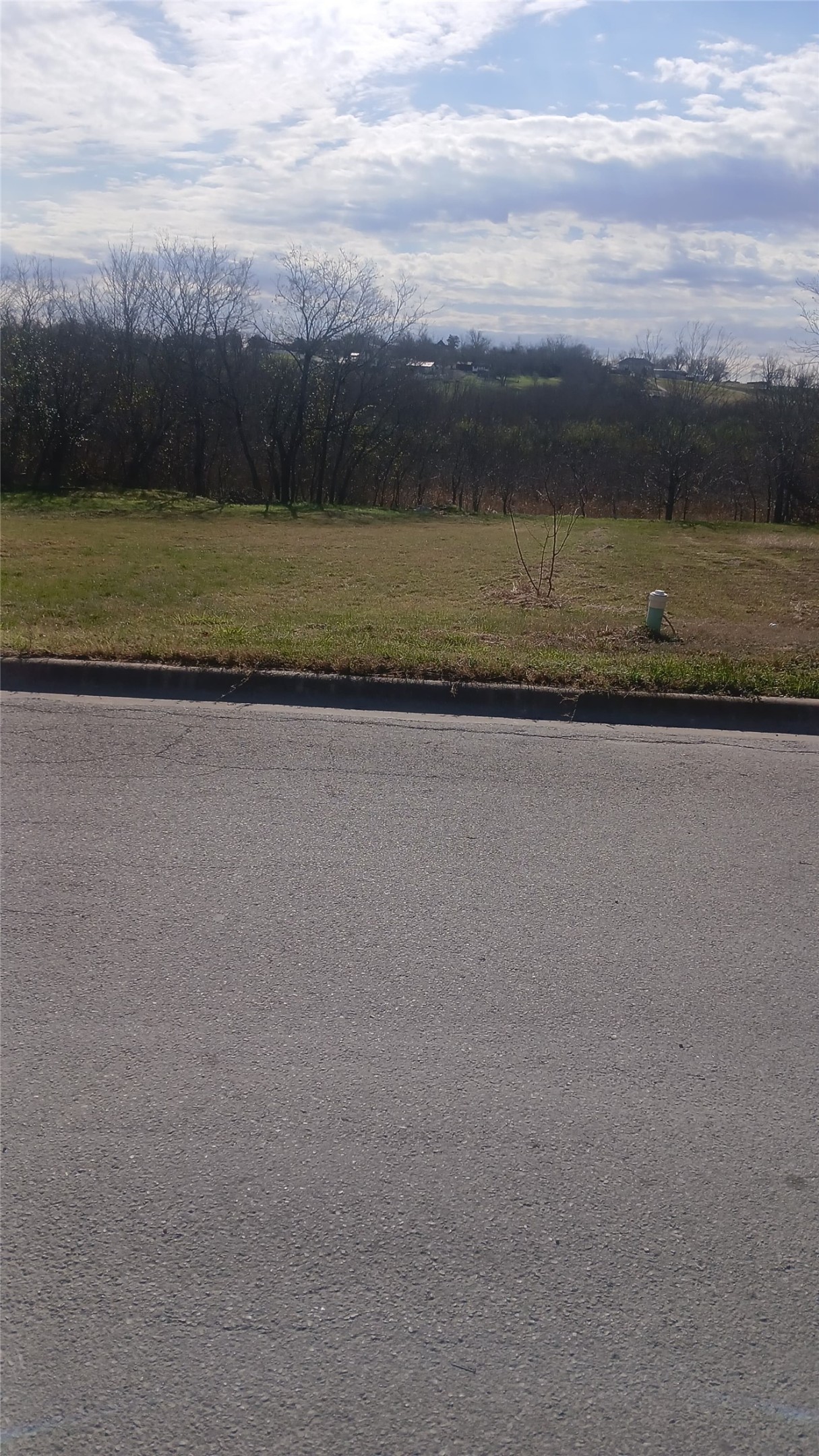 507 West Rio Grande Street, Unit C Taylor, TX 76574 - Photo 1 of 1 View of asphalt street featuring curbs
