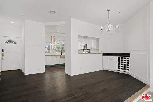 a view of wooden floor and windows in a room