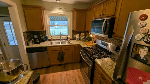 a kitchen with a sink stove and microwave