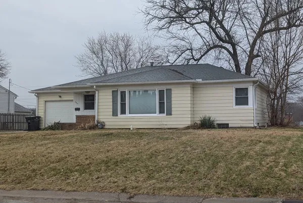 a house that has a tree in front of it