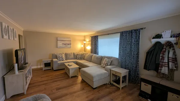 a living room with furniture and a flat screen tv