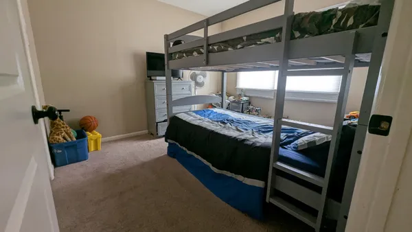 a bed room with a bed and a mirror
