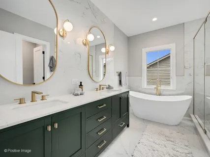 a bathroom with a tub sink and mirror