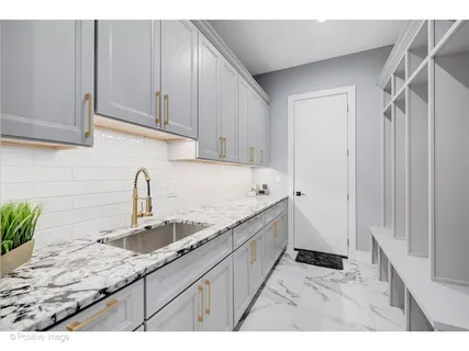 a kitchen with granite countertop a sink and cabinets