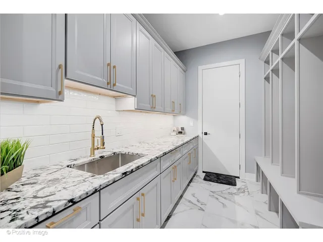 a kitchen with granite countertop a sink and cabinets