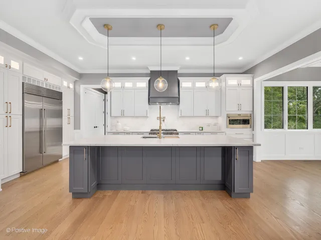 a kitchen with kitchen island a sink and wooden floor