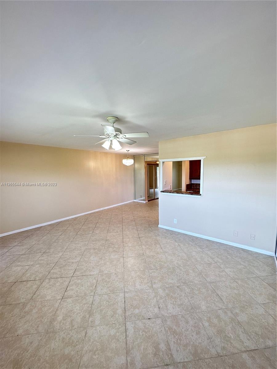 538 Mansfield M, Unit 538 Boca Raton, FL 33434 - Photo 4 of 13 a view of a livingroom with a ceiling fan and window