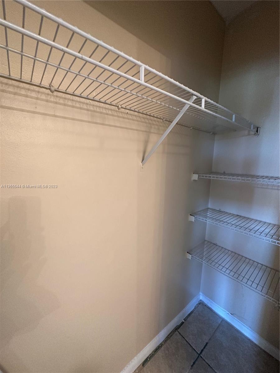 538 Mansfield M, Unit 538 Boca Raton, FL 33434 - Photo 8 of 13 a view of an empty walk in closet