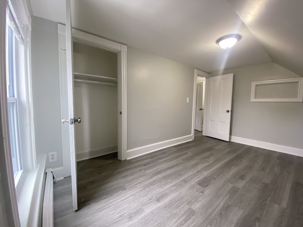 2 Swetts Court Watertown, MA 02472 - Photo 11 of 17 a view of an empty room with wooden floor and a window