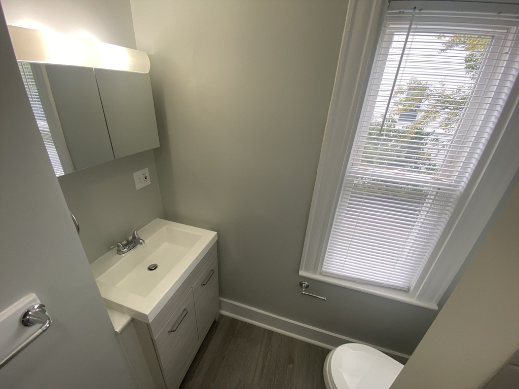 2 Swetts Court Watertown, MA 02472 - Photo 16 of 17 a bathroom with a sink a toilet and window