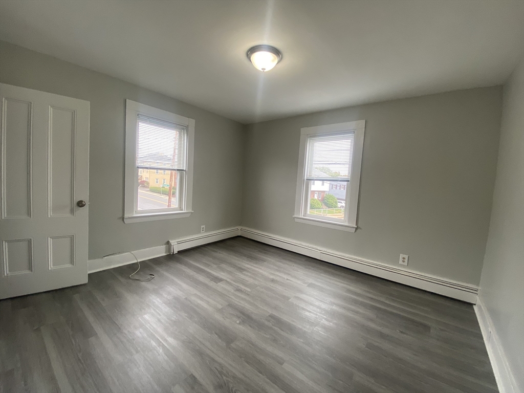 2 Swetts Court Watertown, MA 02472 - Photo 9 of 17 an empty room with wooden floor and windows