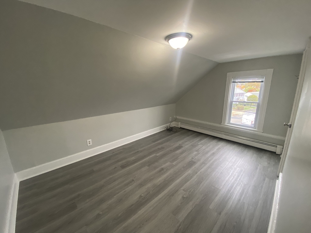 2 Swetts Court Watertown, MA 02472 - Photo 10 of 17 an empty room with wooden floor and windows