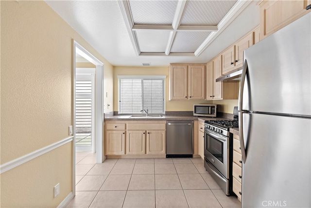 a kitchen with granite countertop white cabinets and appliances
