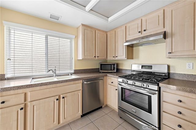 a kitchen with a stove sink and refrigerator