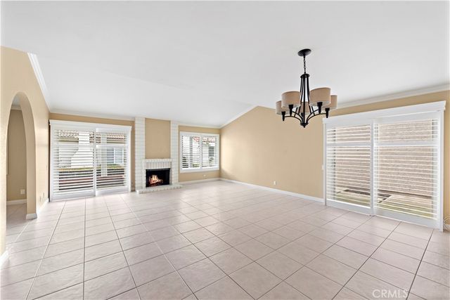a view of a livingroom with a fireplace and window
