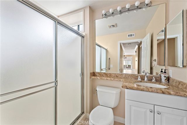 an empty room with chandelier fan and closet