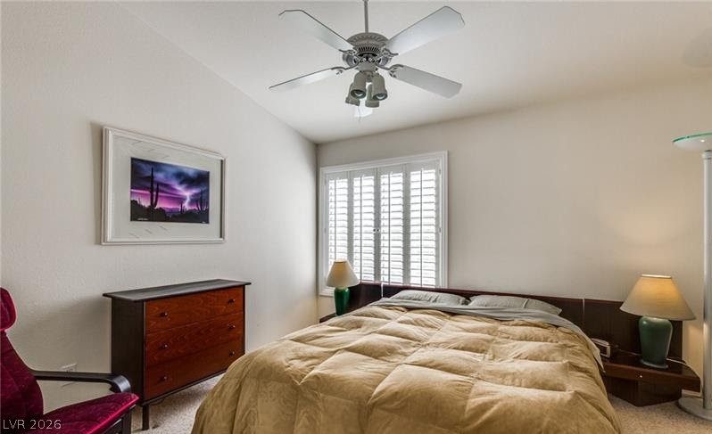 5272 Island Chain Road Las Vegas, NV 89118 - Photo 15 of 31 Relaxation awaits in this cozy bedroom with a ceiling fan and natural light filtering through window shutters.