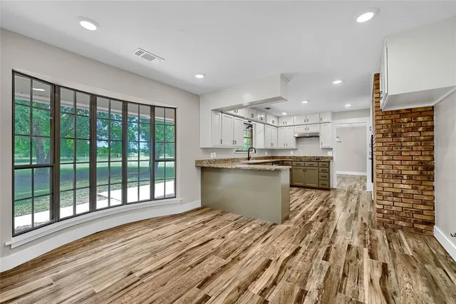 a kitchen with stainless steel appliances kitchen island wooden cabinets and granite counter tops
