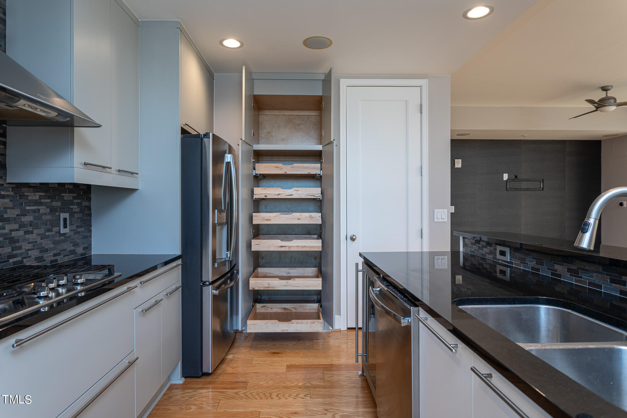 122 North Harrington Street, Unit 1075 Raleigh, NC 27603 - Photo 11 of 38 a kitchen with granite countertop a sink and stainless steel appliances