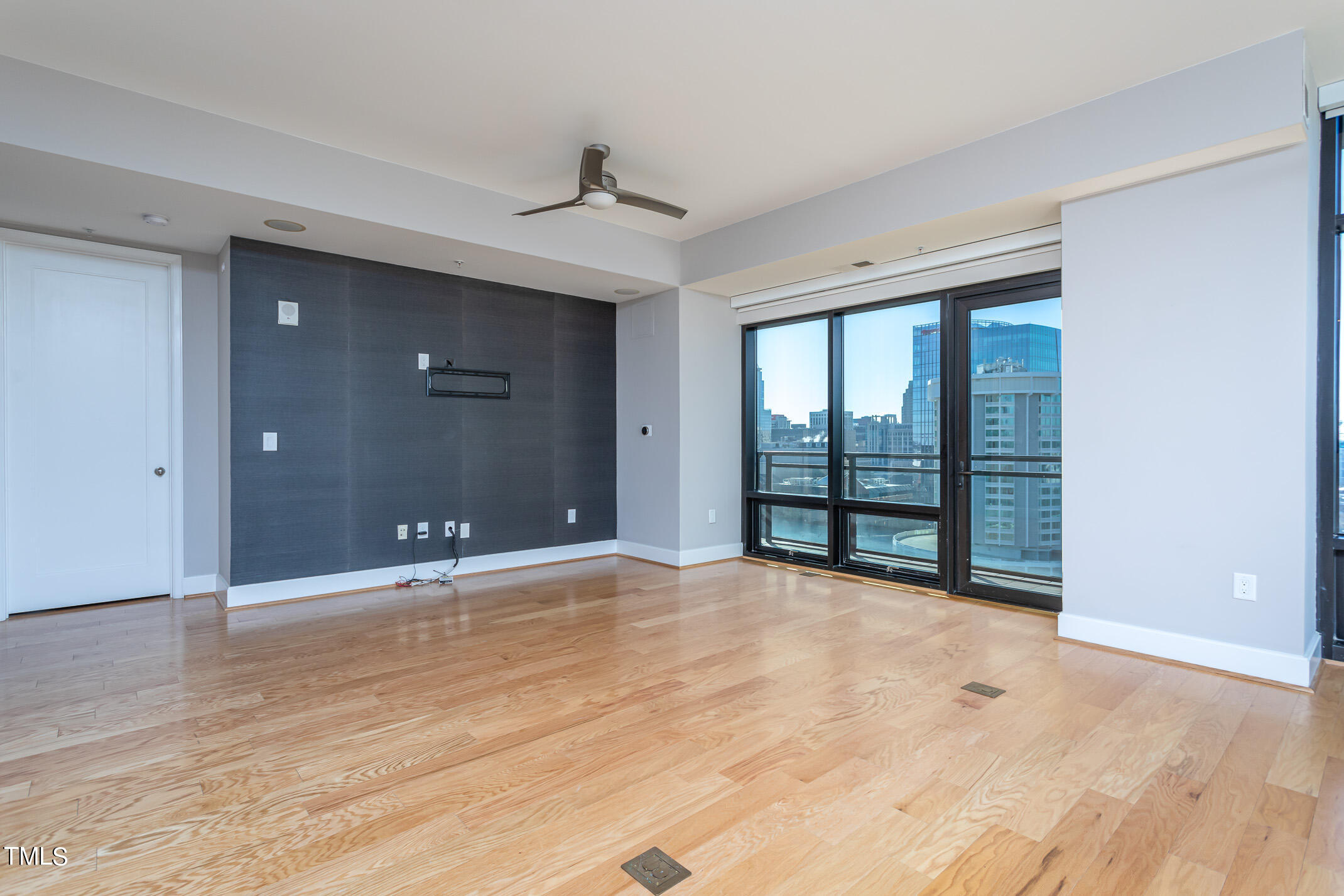 122 North Harrington Street, Unit 1075 Raleigh, NC 27603 - Photo 12 of 38 a view of an empty room with wooden floor and a window