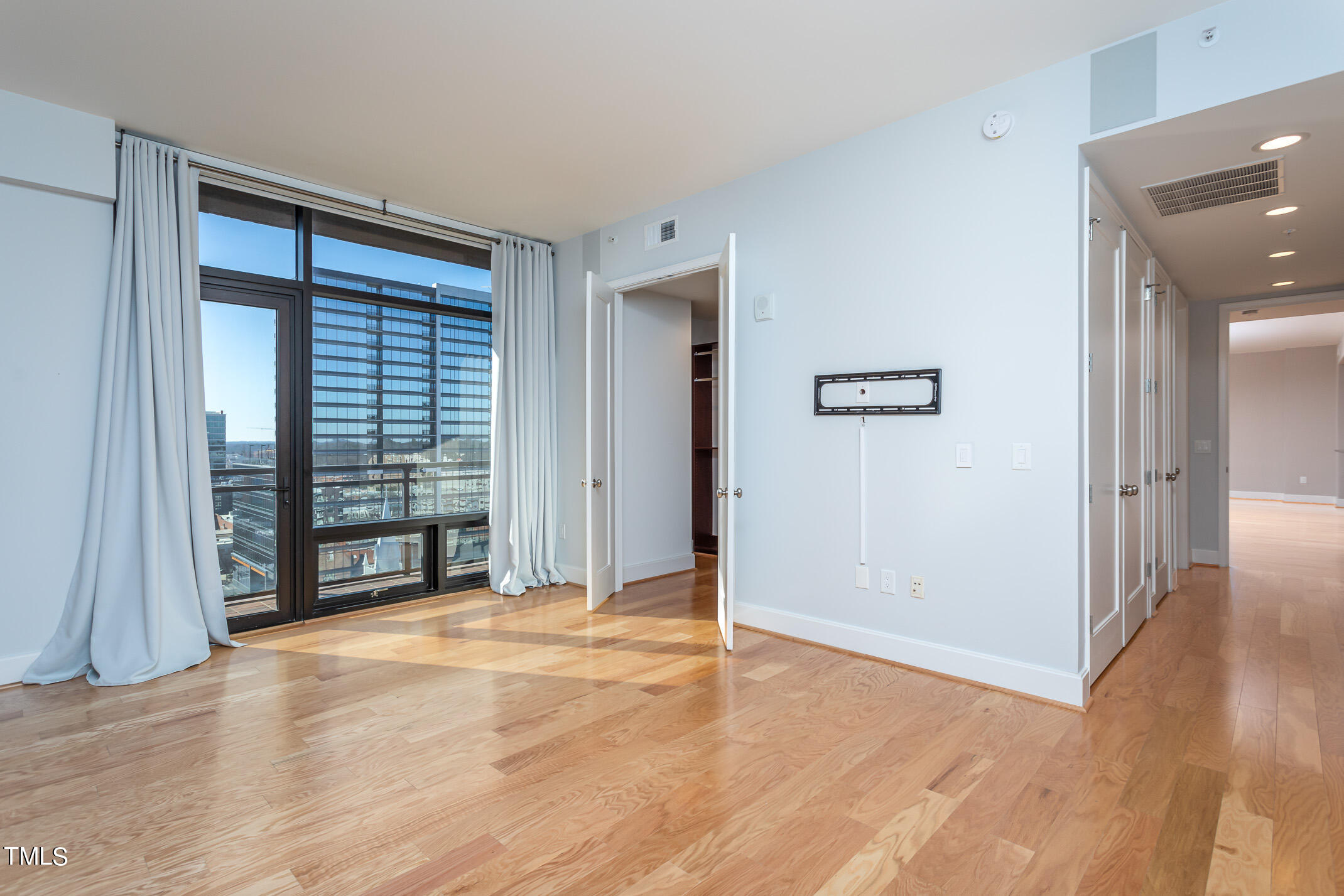 122 North Harrington Street, Unit 1075 Raleigh, NC 27603 - Photo 15 of 38 a view of an empty room with wooden floor and a window
