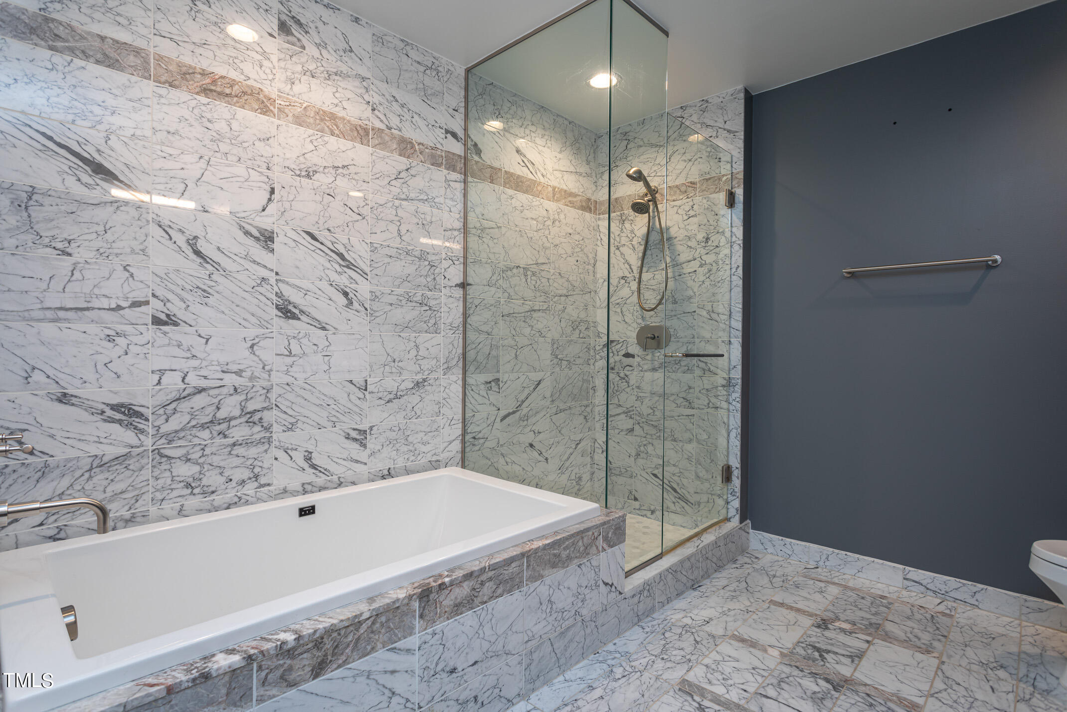 122 North Harrington Street, Unit 1075 Raleigh, NC 27603 - Photo 17 of 38 a bathroom with a bathtub and a shower