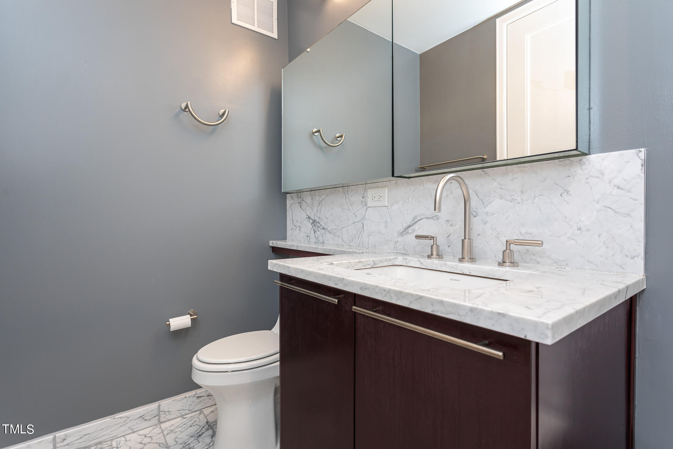 122 North Harrington Street, Unit 1075 Raleigh, NC 27603 - Photo 26 of 38 a bathroom with a granite countertop sink a toilet and a mirror