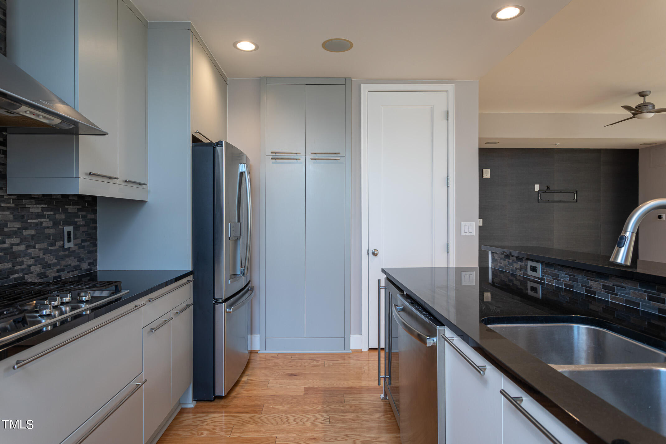 122 North Harrington Street, Unit 1075 Raleigh, NC 27603 - Photo 10 of 38 a kitchen with stainless steel appliances granite countertop a sink and a refrigerator