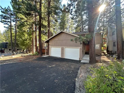 a view of a house with a yard and garage