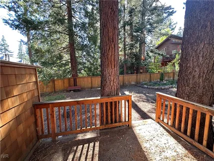 a view of a street with wooden fence