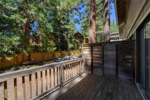 a balcony of view with wooden floor and fence