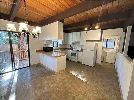 a kitchen with refrigerator and cabinets