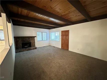 a view of empty room with a fireplace