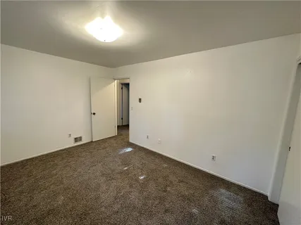 a view of an empty room and a window
