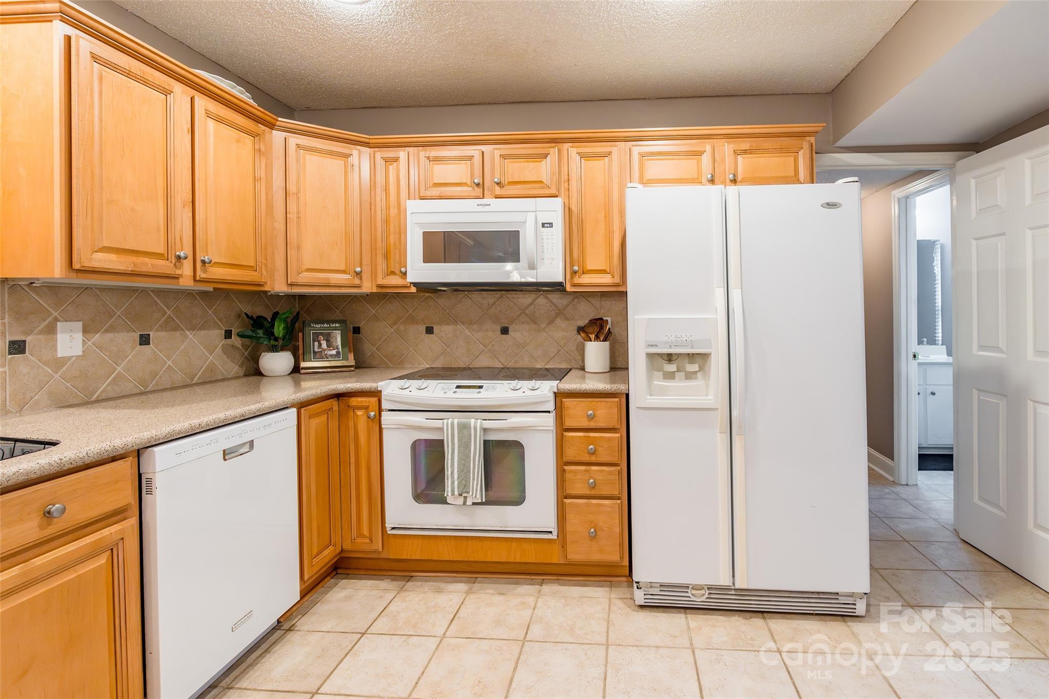 6816 Porterfield Road Charlotte, NC 28226 - Photo 11 of 31 a kitchen with stainless steel appliances a stove sink and refrigerator