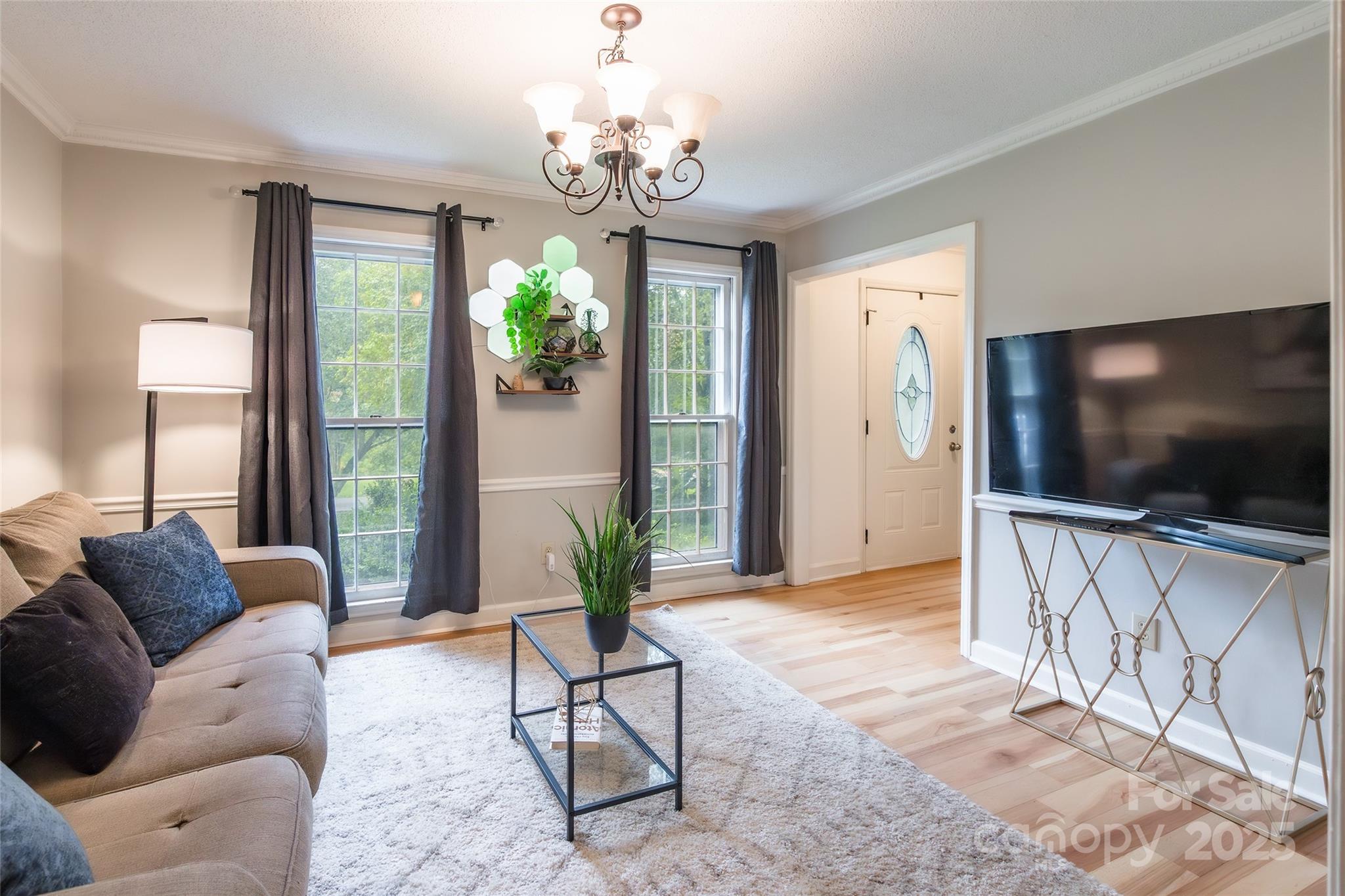 6816 Porterfield Road Charlotte, NC 28226 - Photo 12 of 31 a living room with furniture and a flat screen tv