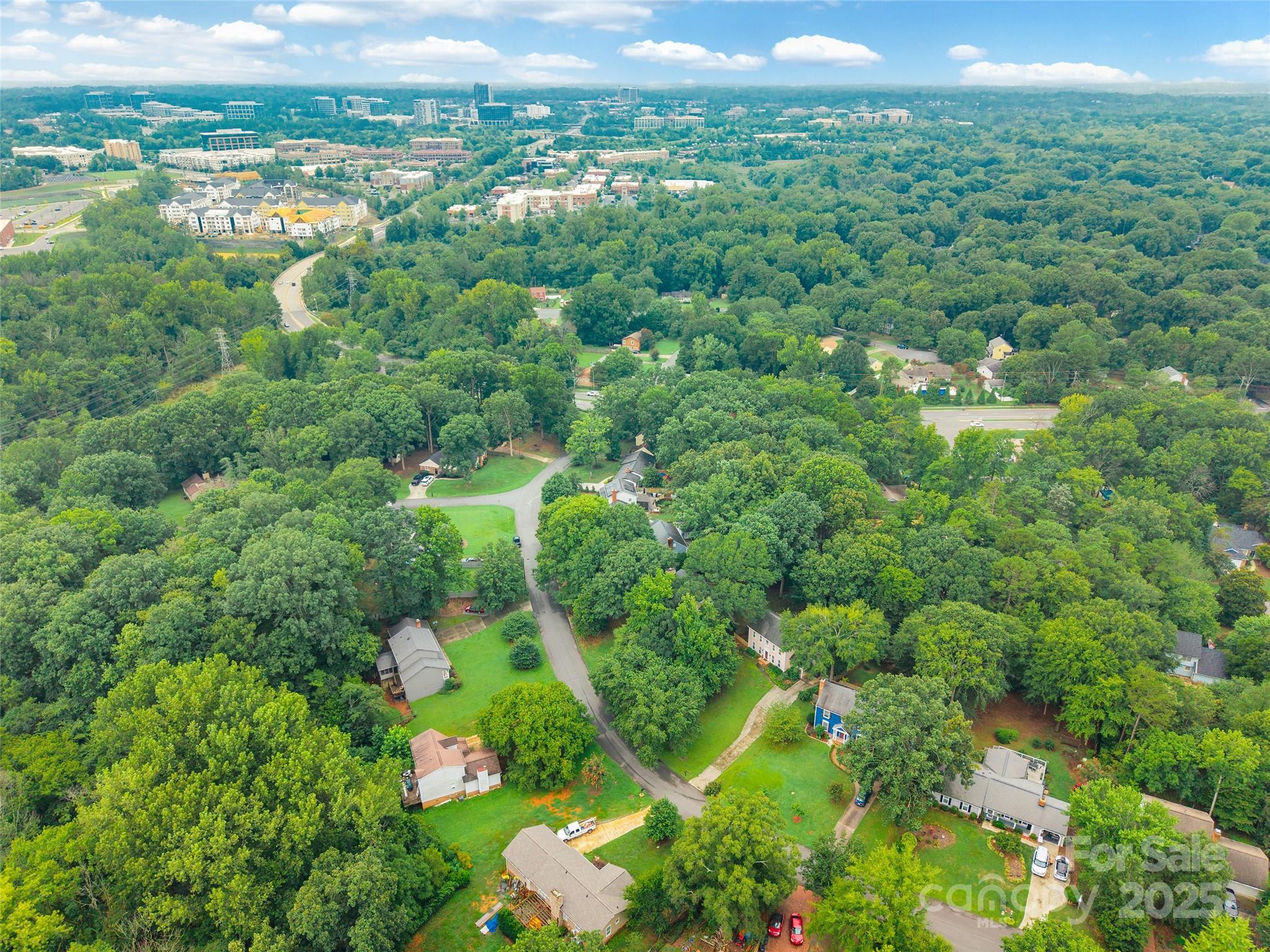 6816 Porterfield Road Charlotte, NC 28226 - Photo 30 of 31 a view of a city with lush green forest