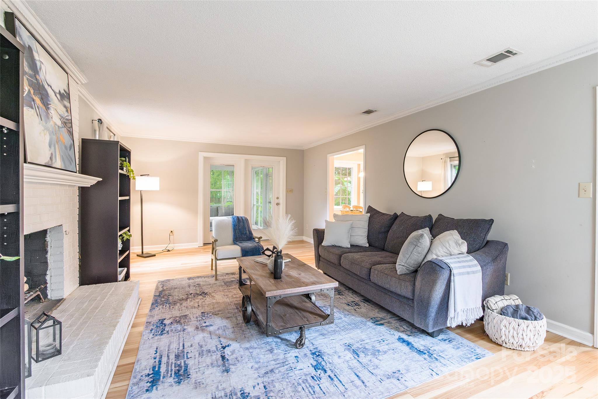 6816 Porterfield Road Charlotte, NC 28226 - Photo 5 of 31 a living room with furniture a fireplace and a large window