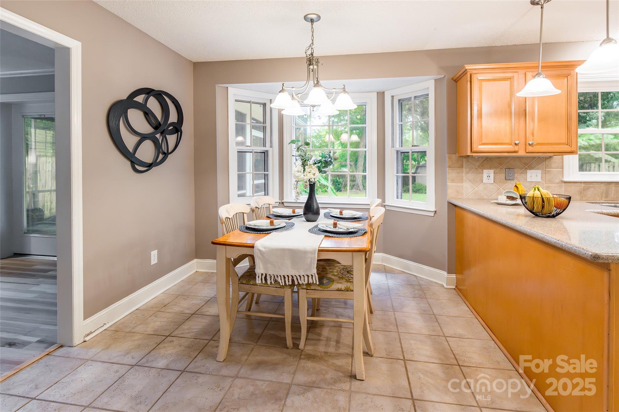 6816 Porterfield Road Charlotte, NC 28226 - Photo 8 of 31 a dining room filled with lots of furniture and window