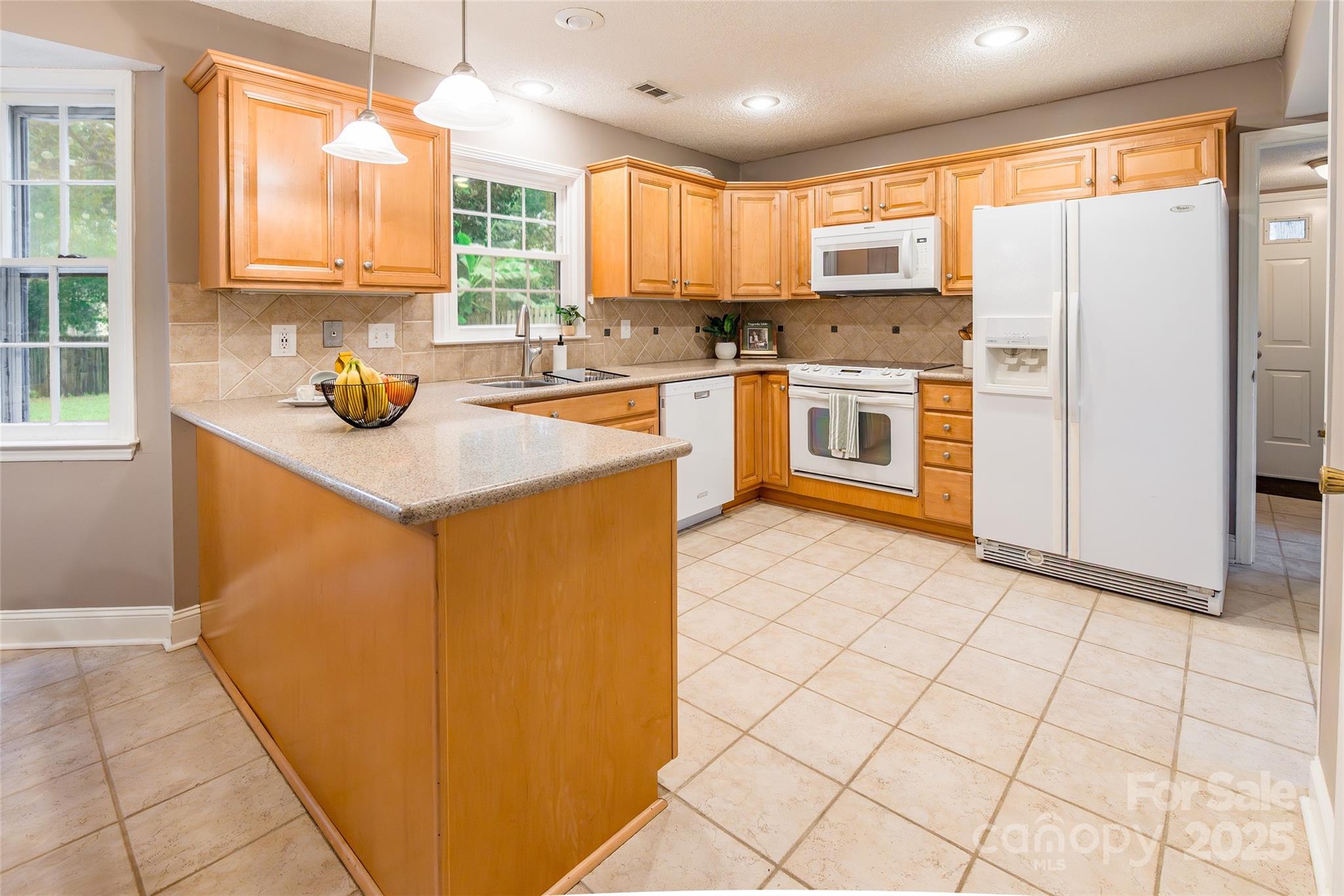 6816 Porterfield Road Charlotte, NC 28226 - Photo 9 of 31 a kitchen with stainless steel appliances cabinets a sink and a window