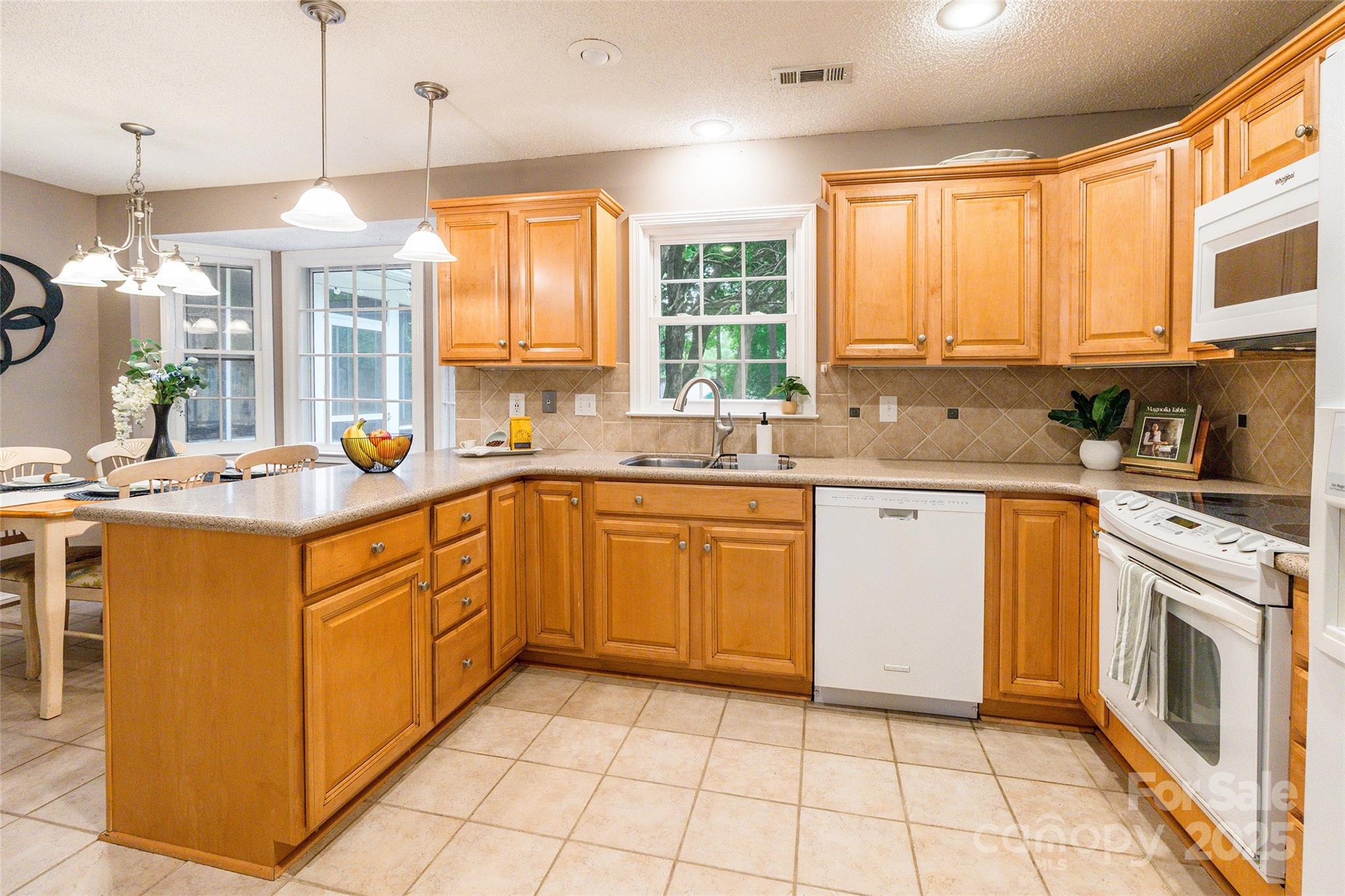 6816 Porterfield Road Charlotte, NC 28226 - Photo 10 of 31 a kitchen with a sink stove and cabinets