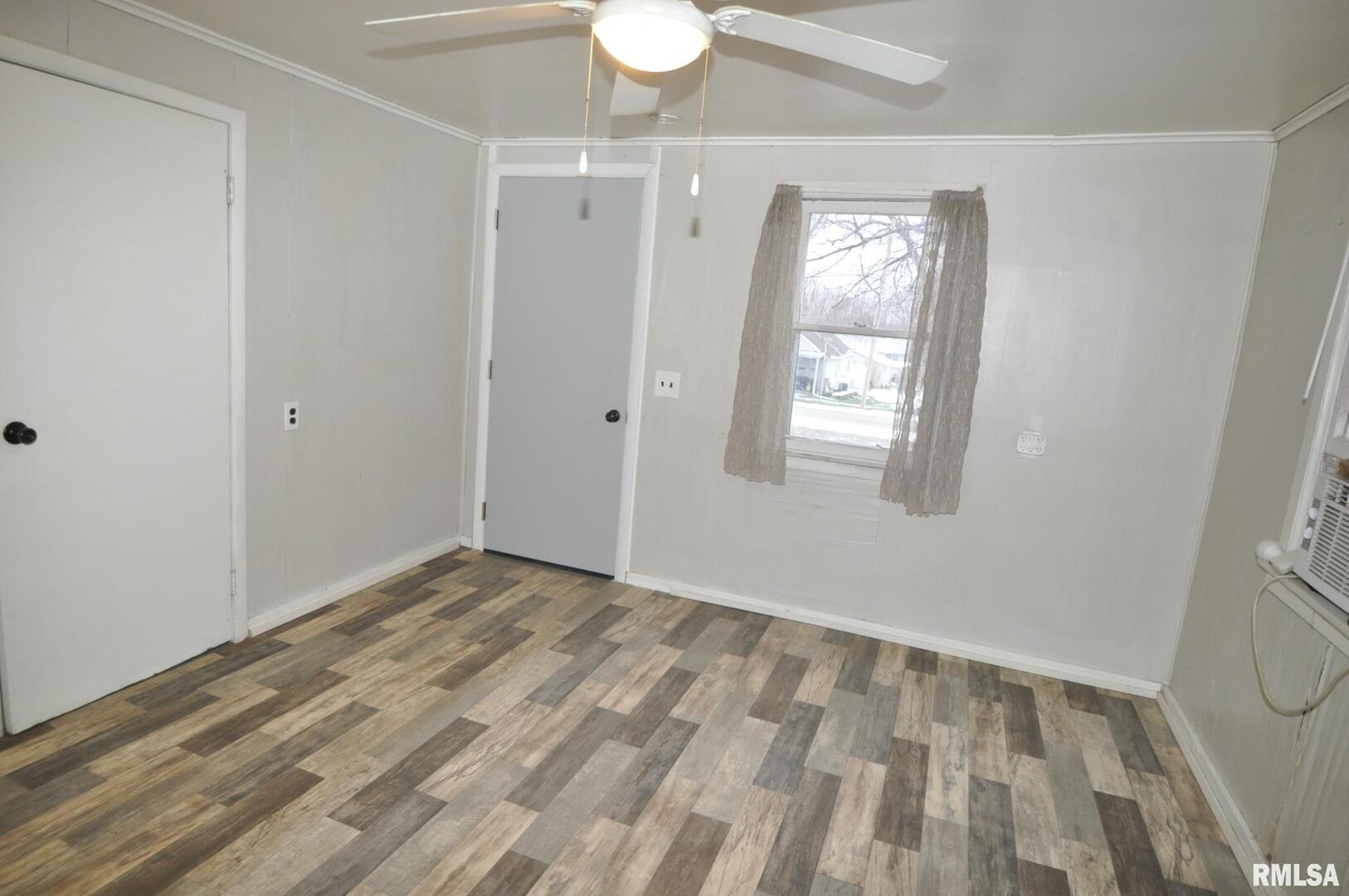 224 4th Street Colona, IL 61241 - Photo 2 of 12 a view of room with window and hardwood floor