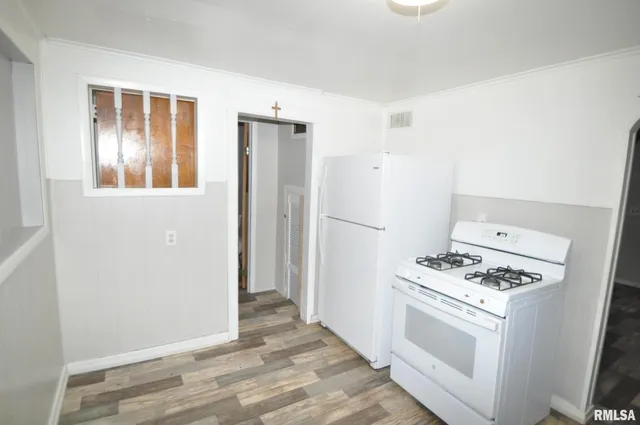 a kitchen with a stove and a refrigerator