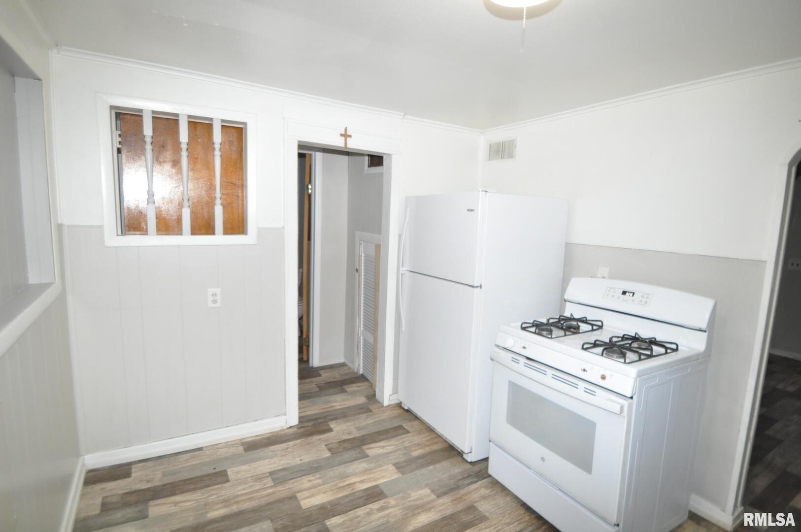 224 4th Street Colona, IL 61241 - Photo 6 of 12 a kitchen with a stove and a refrigerator