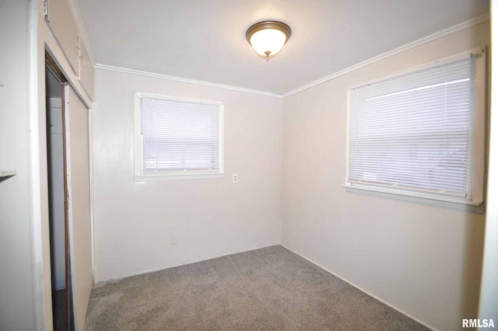 224 4th Street Colona, IL 61241 - Photo 9 of 12 an empty room with windows
