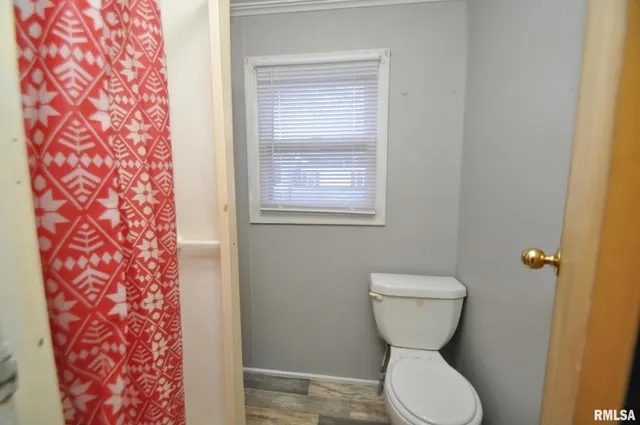 a bathroom with a toilet and a shower