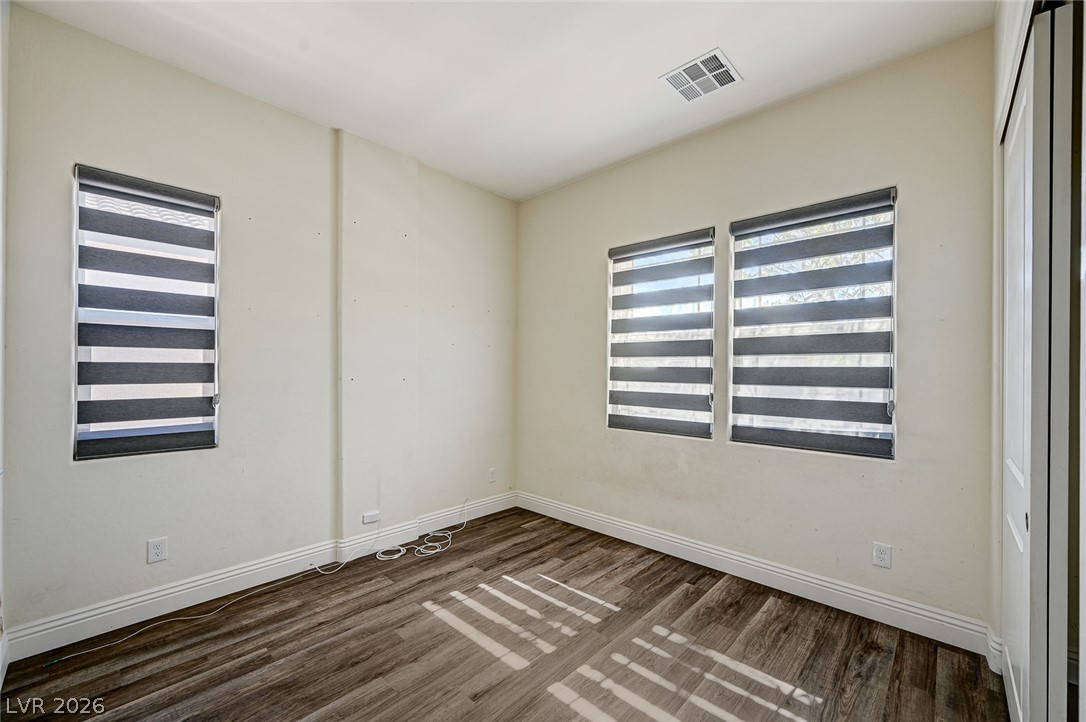 8197 Riley Love Street Las Vegas, NV 89139 - Photo 5 of 48 Sun-filled room boasts resilient vinyl plank flooring and modern window treatments.