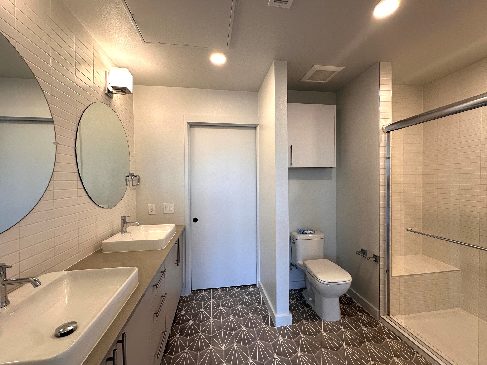 4004 Banister Lane, Unit 312 Austin, TX 78704 - Photo 22 of 27 Full bath featuring a stall shower, double vanity, and recessed lighting